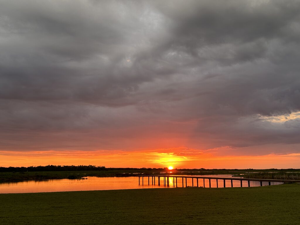 Orange sunset with the dock in a Florida cove of Lake Toho