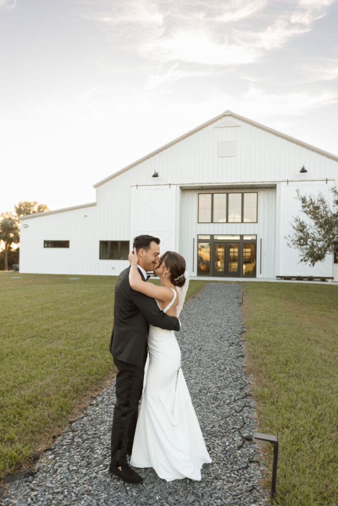 orlando farm wedding, married couple in front of barn wedding venue in saint cloud florida