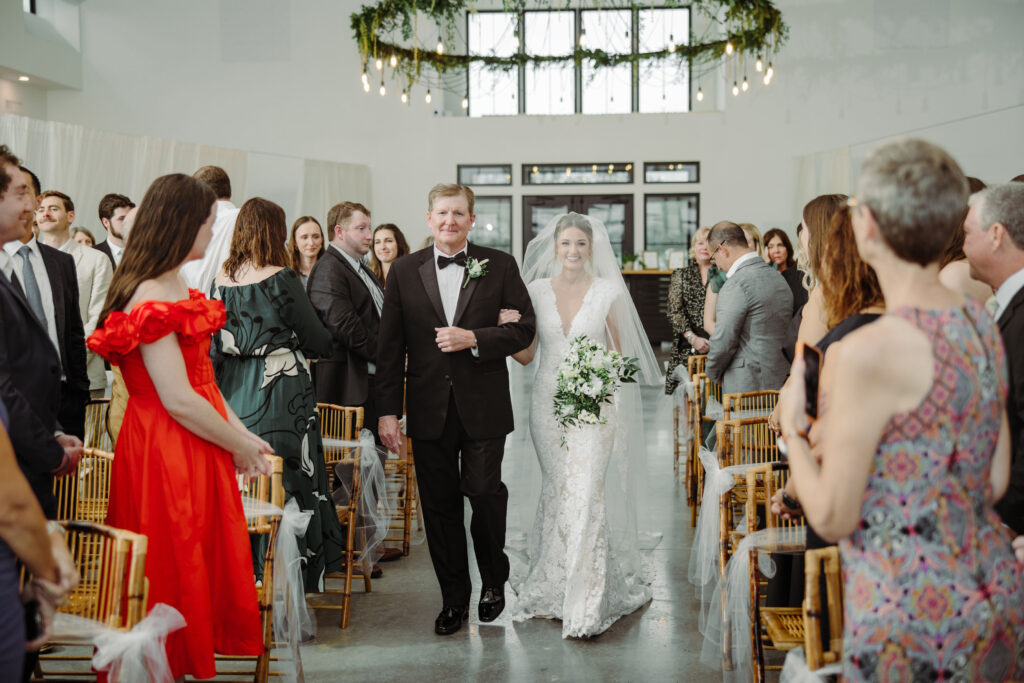 indoor wedding ceremony at orlando barn venue, father of the bride walking daughter down the aisle, 