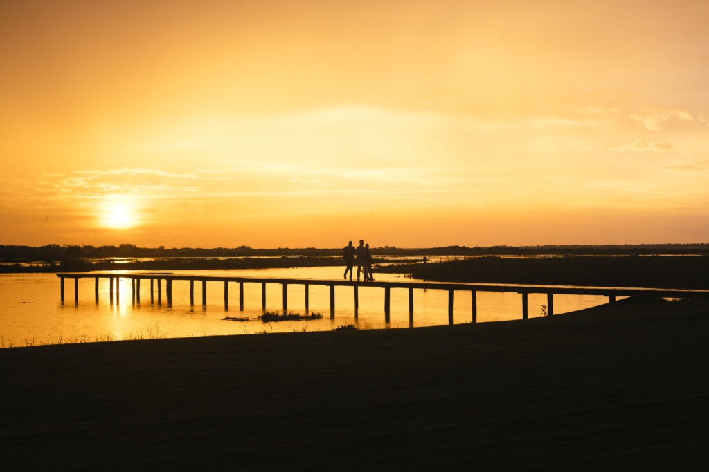 florida sunset lakeside at central florida luxury barn wedding venue, wedding guests at sunset
