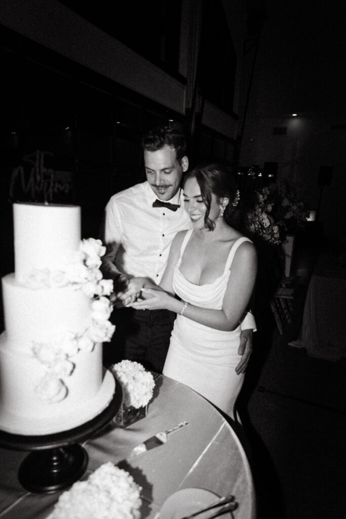 bride and gourmet cutting the cake at reception at Orlando, Florida wedding venue