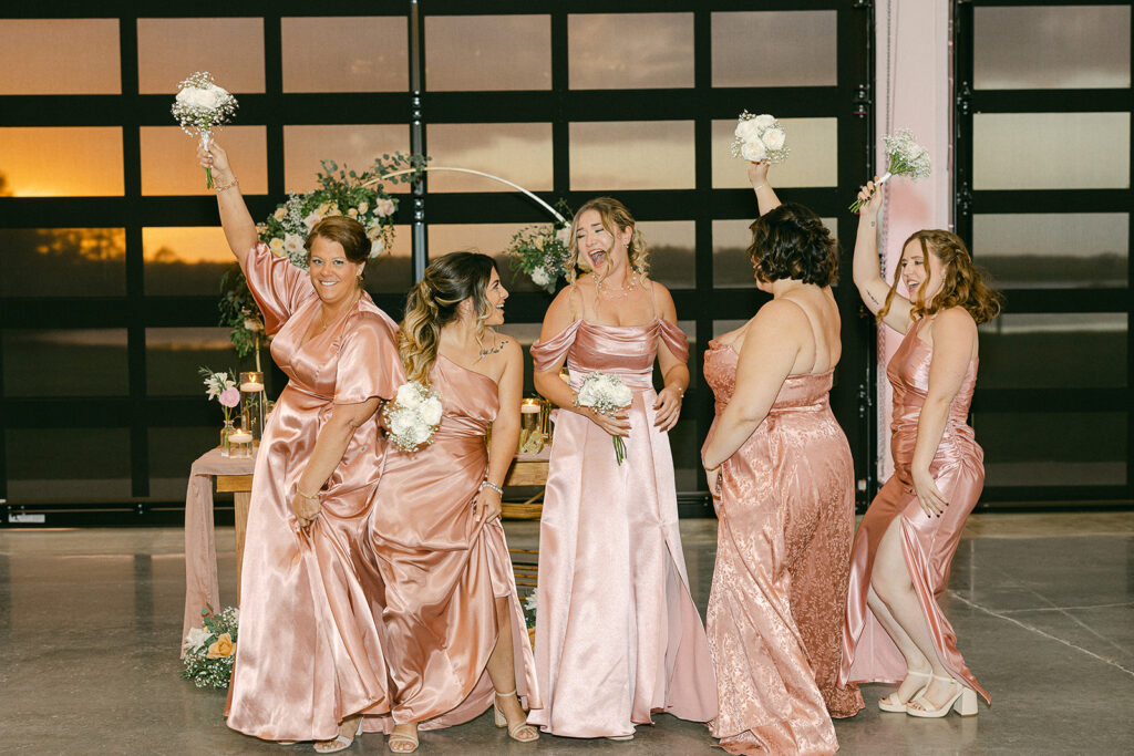 bridesmaids dancing at florida wedding venue at sunset