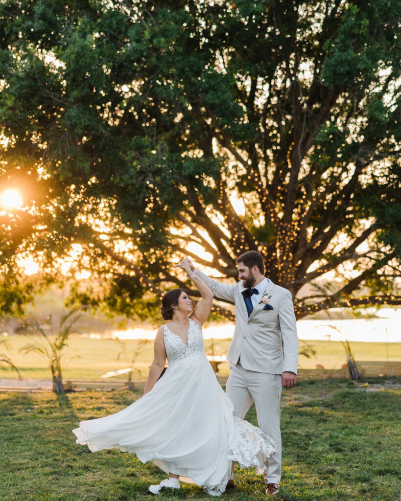 newlywed couple dance at golden hour at wedding venue in Saint Cloud, Florida, lakeside wedding venue near Kissimmee