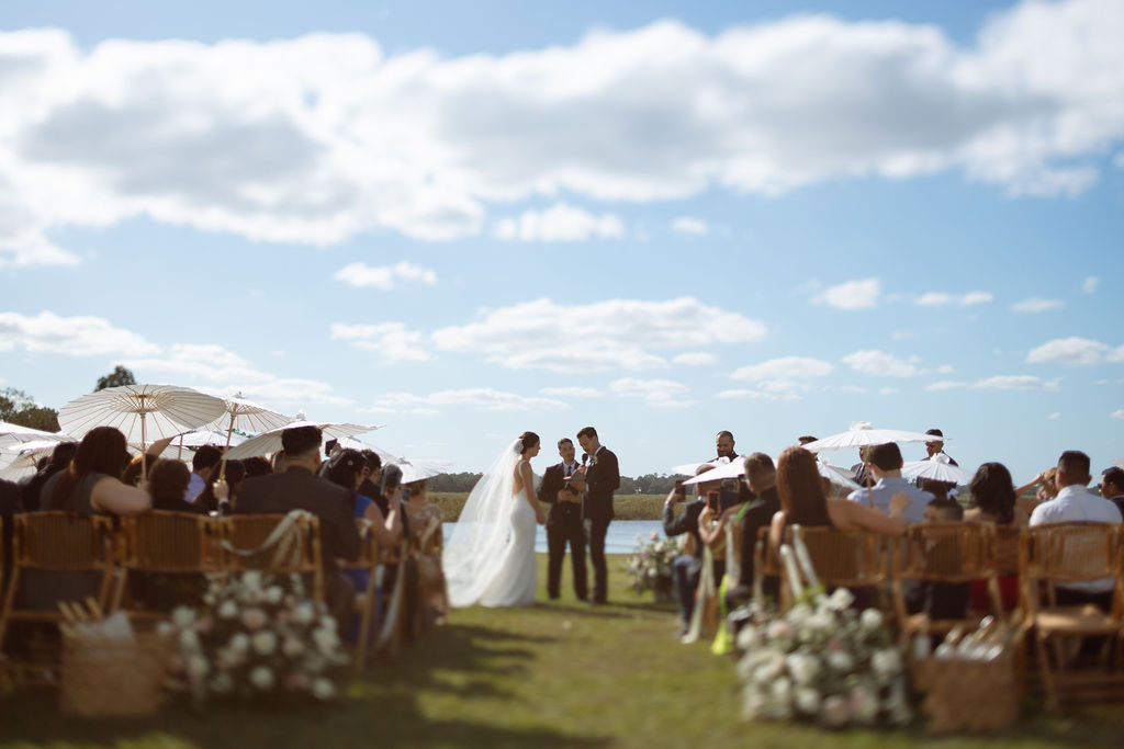 lakeside wedding venue in Saint Cloud, Florida near Orlando, Bride and groom saying their vows at luxury barn venue in Central Florida