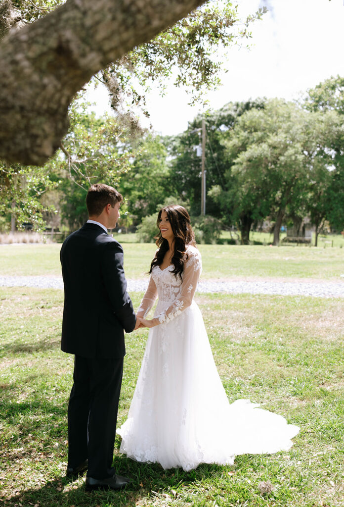 bride and groom sharing a first look outside of barn venue near Kissimmee, Florida