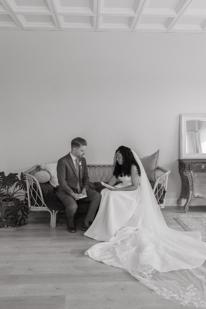 Bride and groom reading their private vows in the bridal suite of Lavender on the Lake, a wedding venue in Central Florida.
