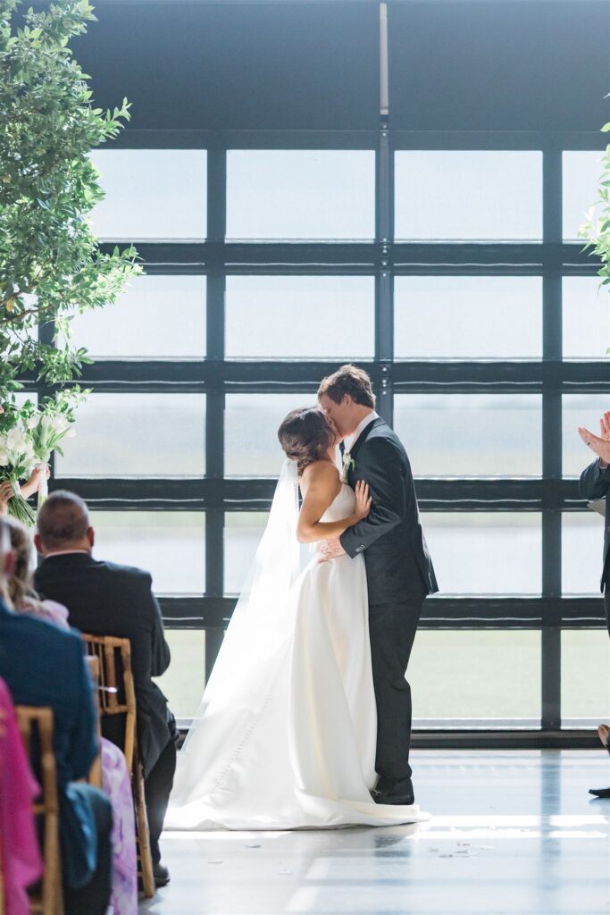 newlywed Orlando couple share their first kiss in Lavender on the Lake, a luxury barn wedding venue