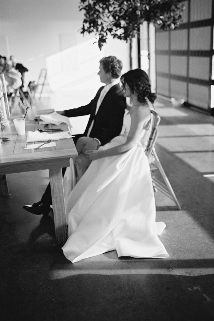 bride and groom listening to toasts during reception at Lavender on the Lake, a wedding venue near Kissimmee, Florida, lakeside venue