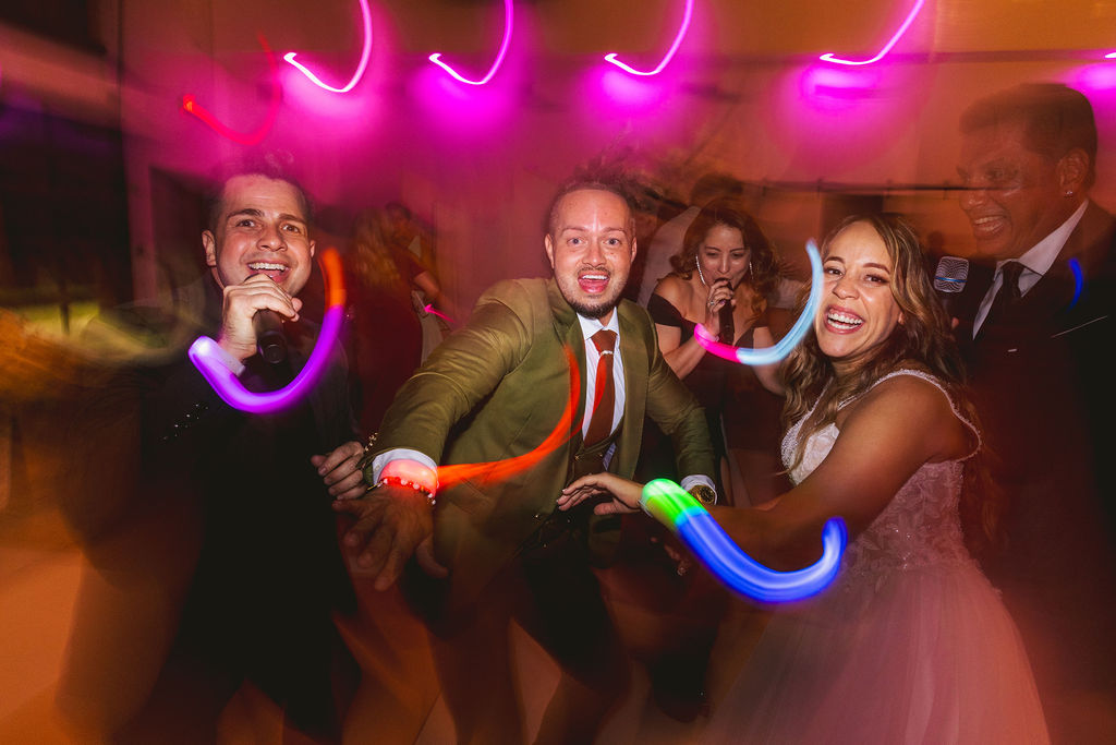 bride, groom and guest dancing at lakeside wedding venue in Florida wedding venue
