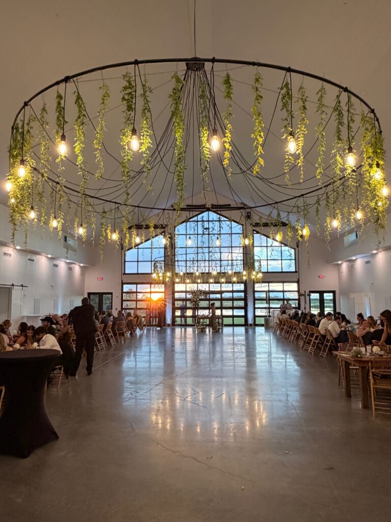 Chandeliers with wisteria hanging in wedding reception space at wedding venue in Orlando