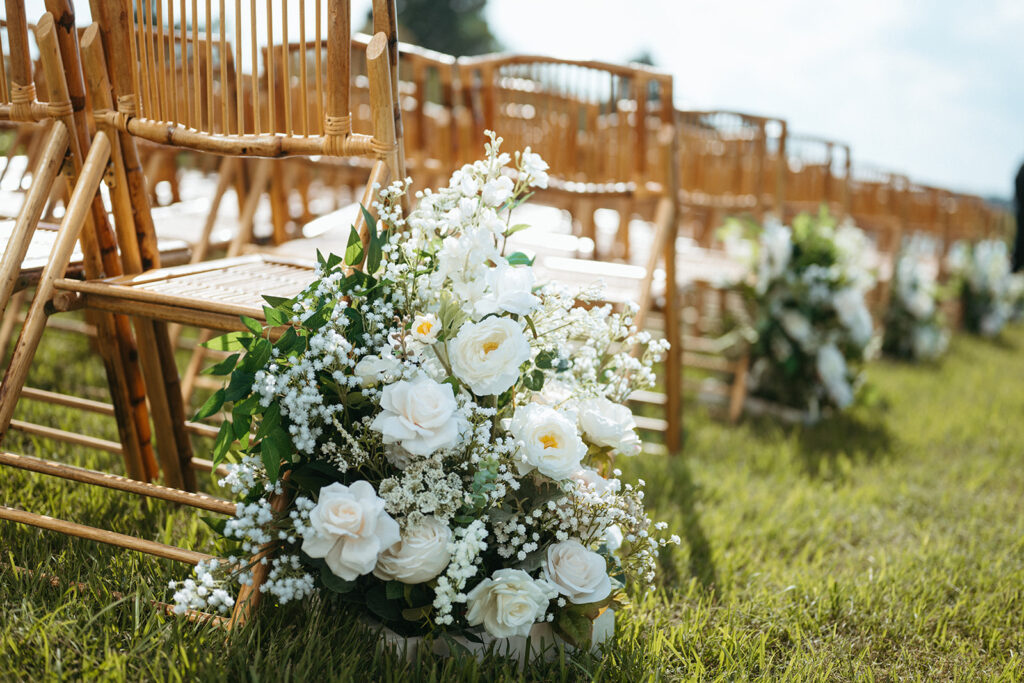 wedding flowers place on the aisle for ceremony at lakeside wedding venue