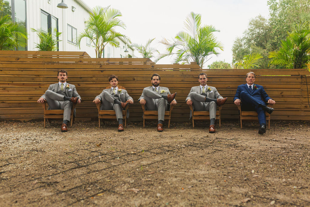 groom and groomsmen at cocktail hour after ceremony at wedding venue