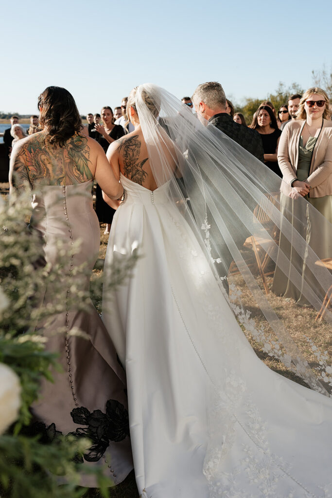 bride walking down the aisle for summer wedding at Lavender on the Lake in Saint Cloud, Florida