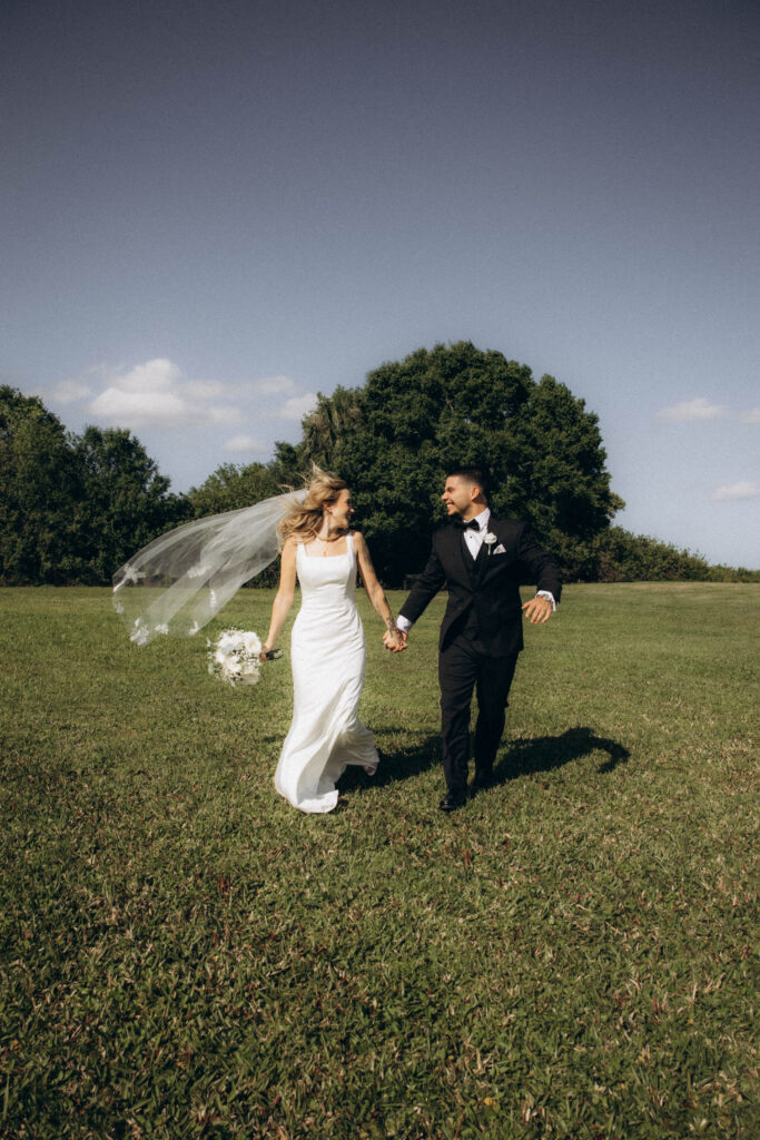 bride and groom in the field at wedding barn venue near Orlando, Florida