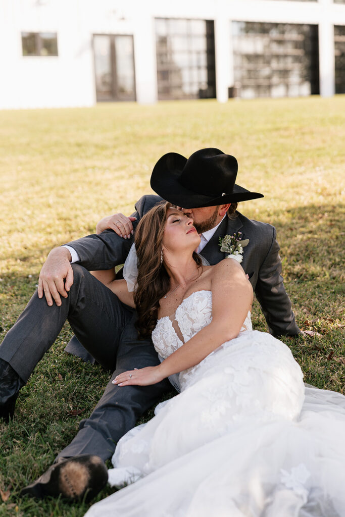 bride and groom sitting outside at the Florida farm wedding venue