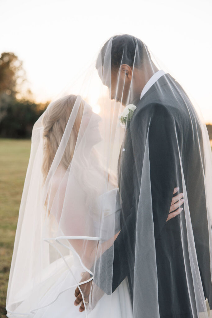 bride and groom under the veil for those after wedding ceremony photos
