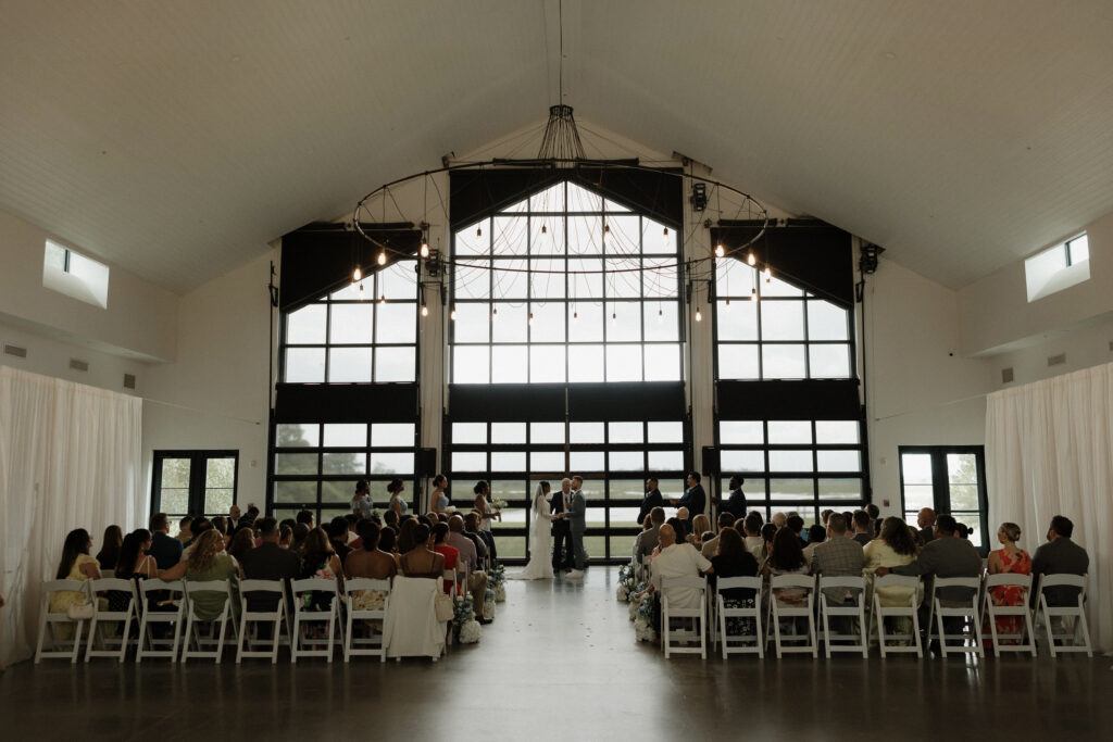 indoor wedding ceremony, bride and groom saying their vows during their wedding