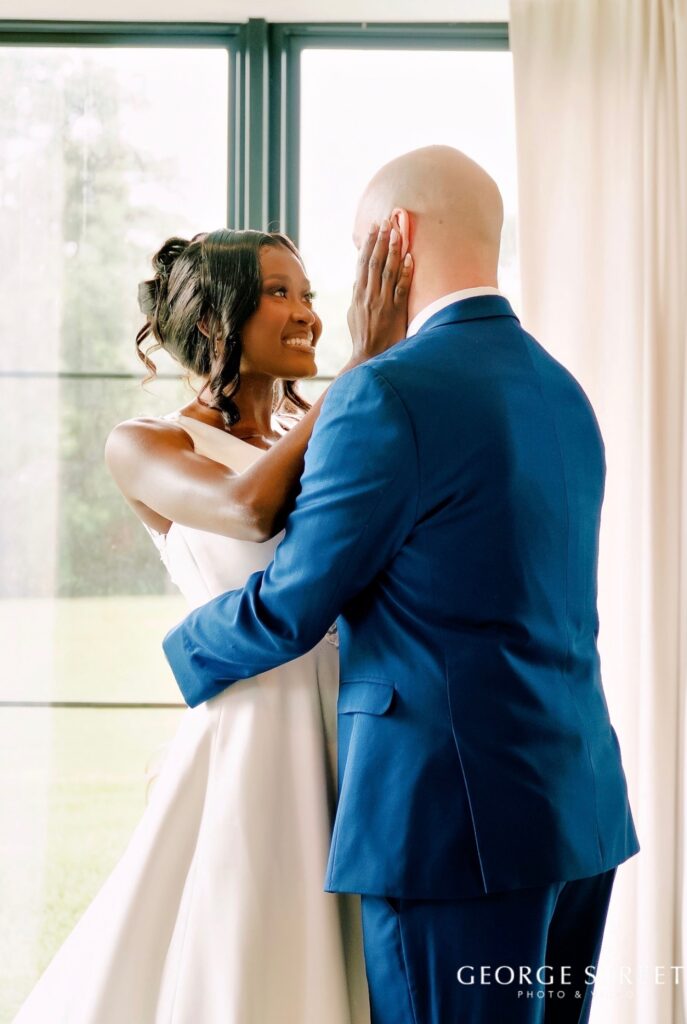bride and groom sharing a private moment in the bridal suite after indoor wedding ceremony