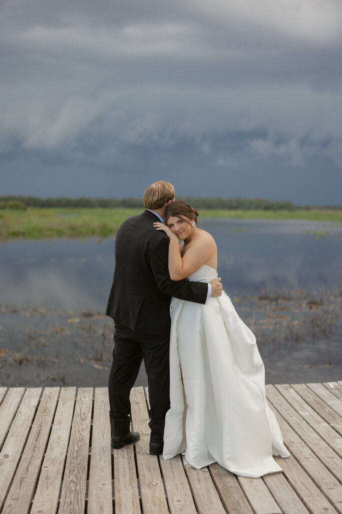 bride and groom on the dock at Lavender on the Lake a venue in Saint Cloud, Florida