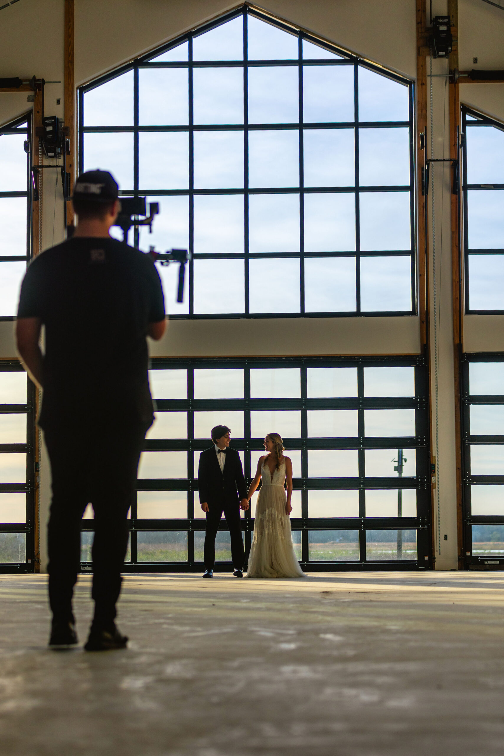 orlando wedding venue, man holding video camera, bride and groom, window in wedding venue