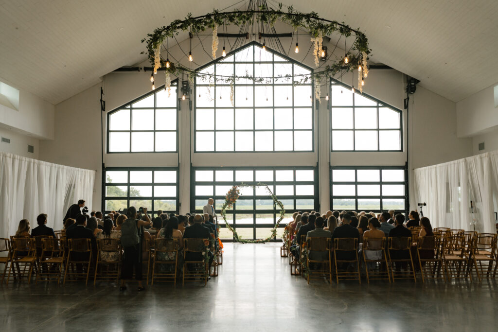 inside wedding ceremony with florals on chandelier