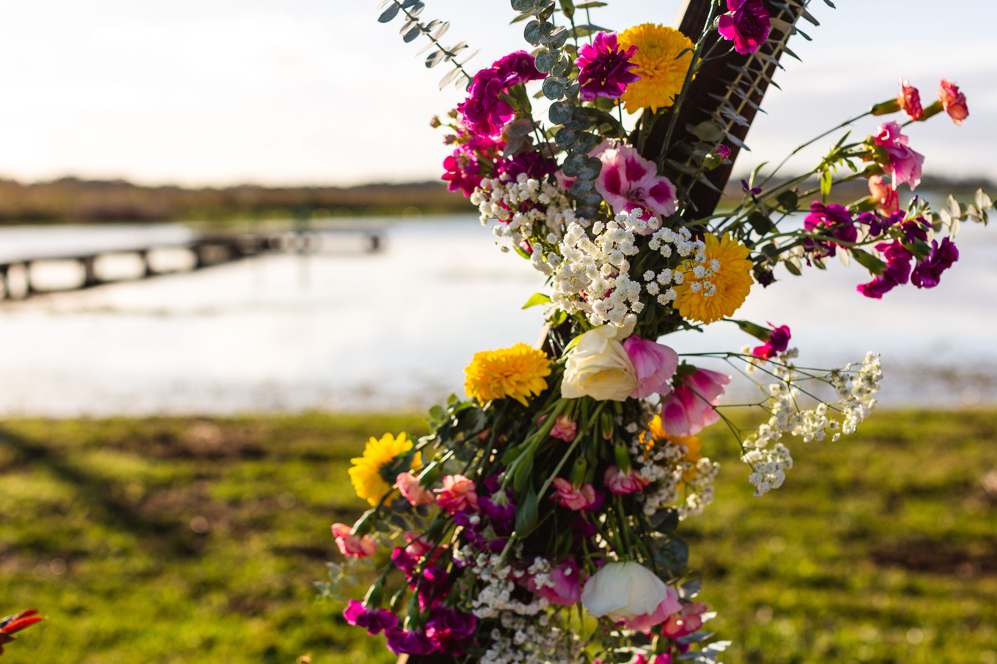 ceremony arch, wedding florals, flowers, lakeside weddings, seeking joy during wedding planning