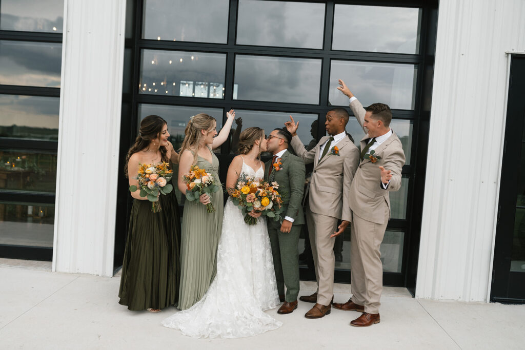 bride and groom kissing after the wedding ceremony, bridal party, love