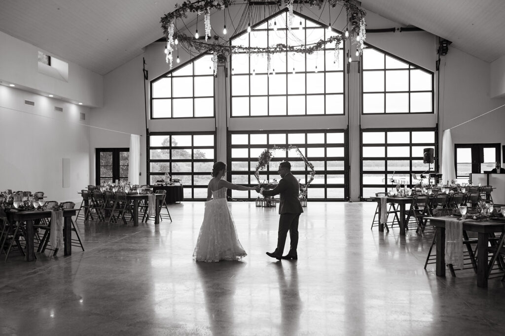 bridal couple having a private dance in reception space
