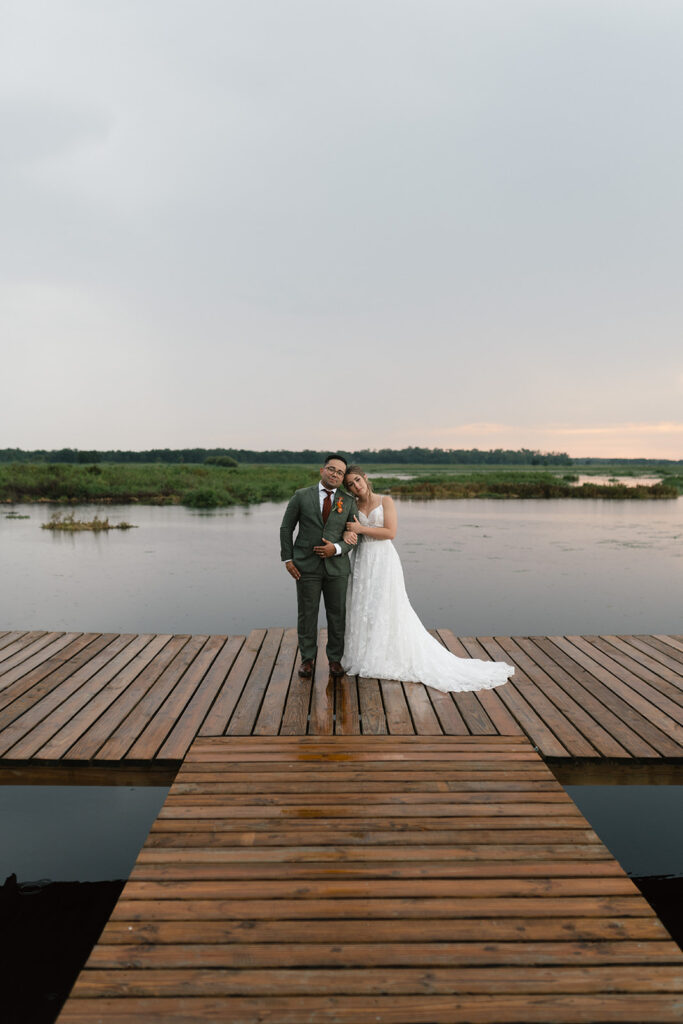 bride and groom on the dock at sunset on Lake Tohopekaliga in Saint Cloud Florida
