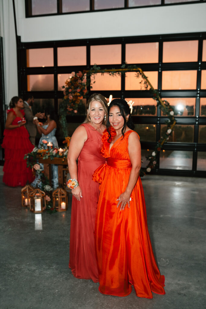 mother of the groom with mother of the bride in wedding venue during Florida sunset
