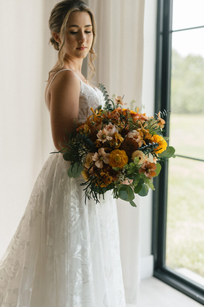 bride holding her bouquet in the the getting ready room at Florida barn wedding venue